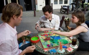 three people playing a board game